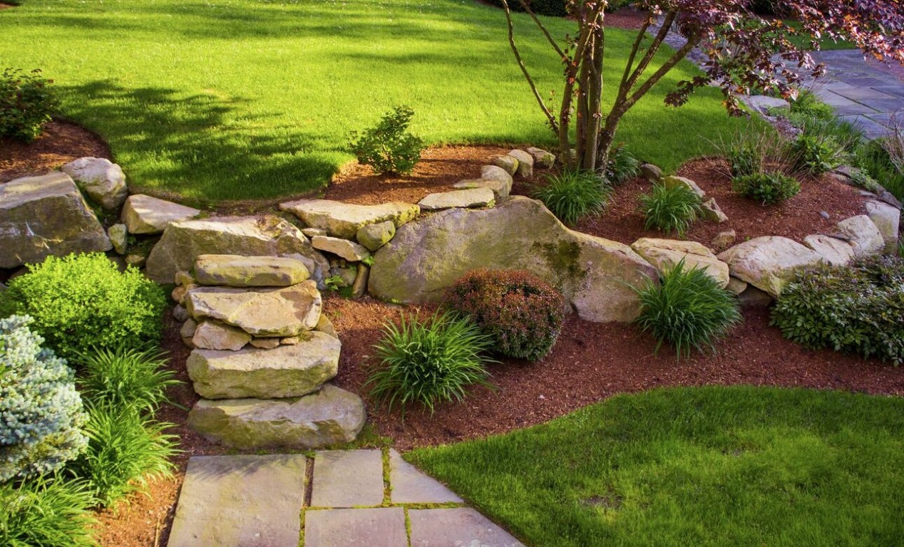 Professional landscape design with stone steps and ornamental plantings in Westchester, FL